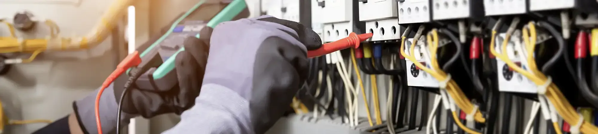 Electrician working fuse board